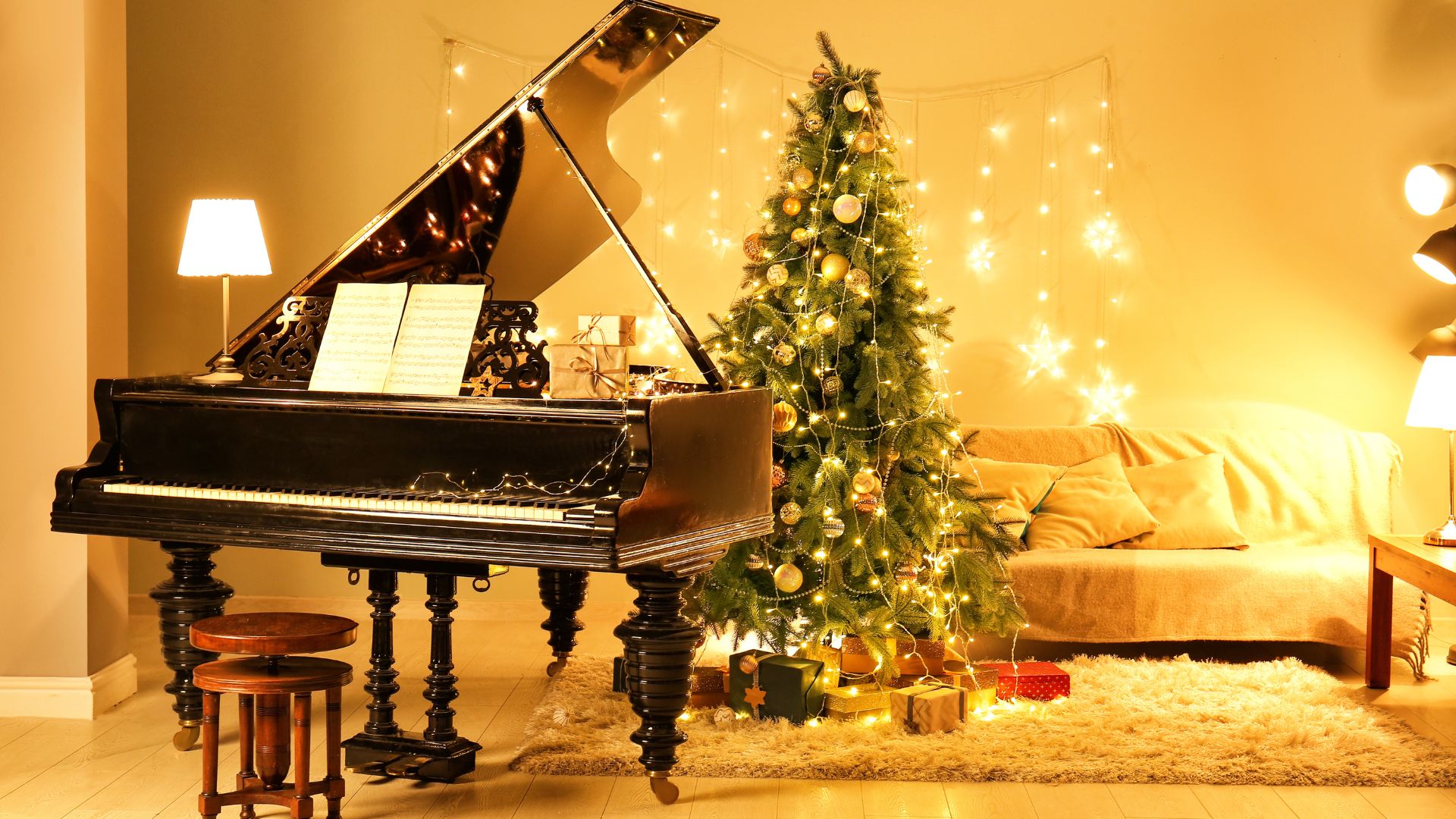 Grand piano with sheet music next to decorated Christmas tree in warm golden-lit room.