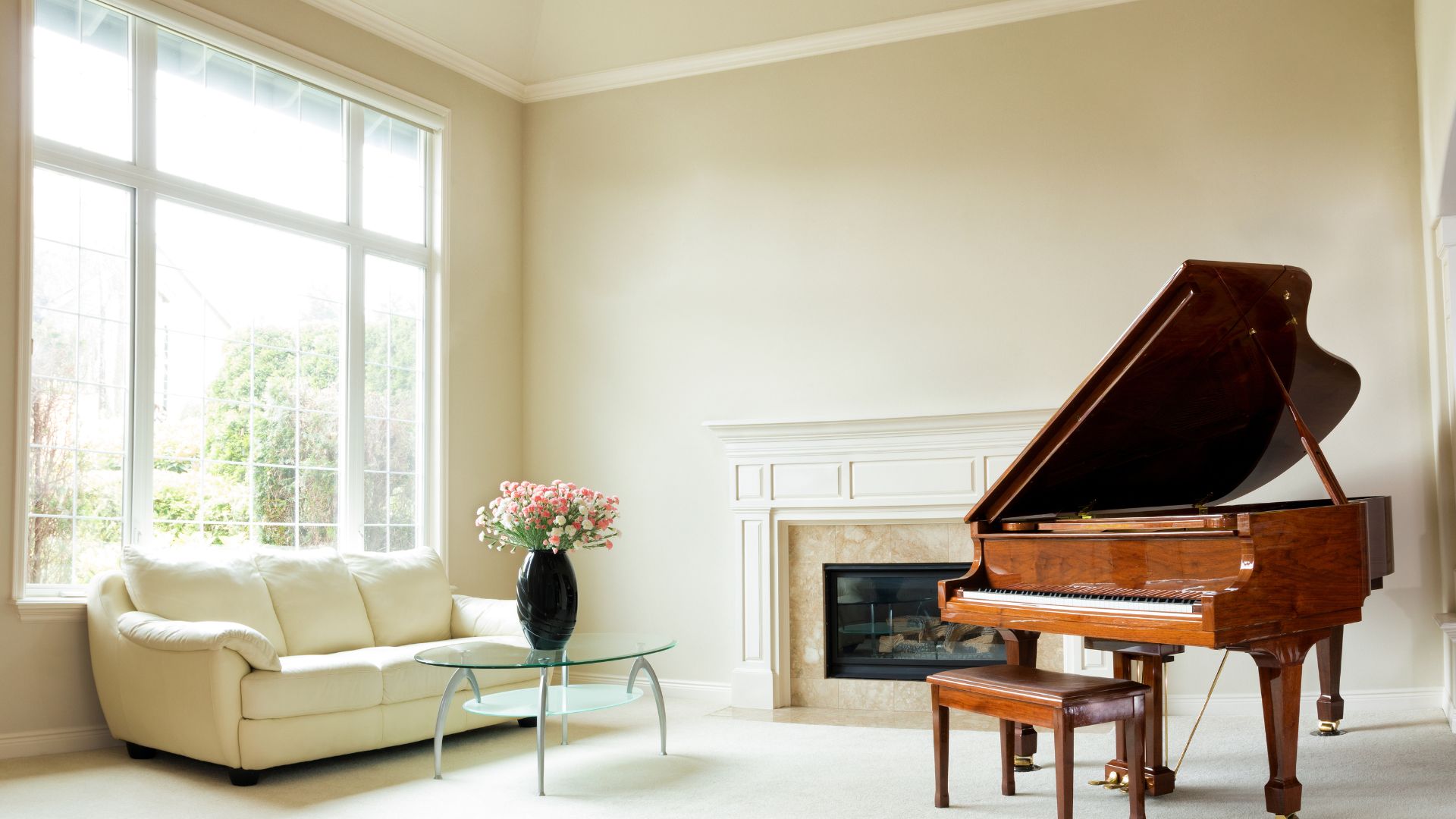 A living room filled with furniture and a grand piano